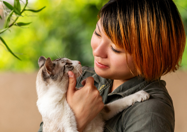 a woman holding a cat