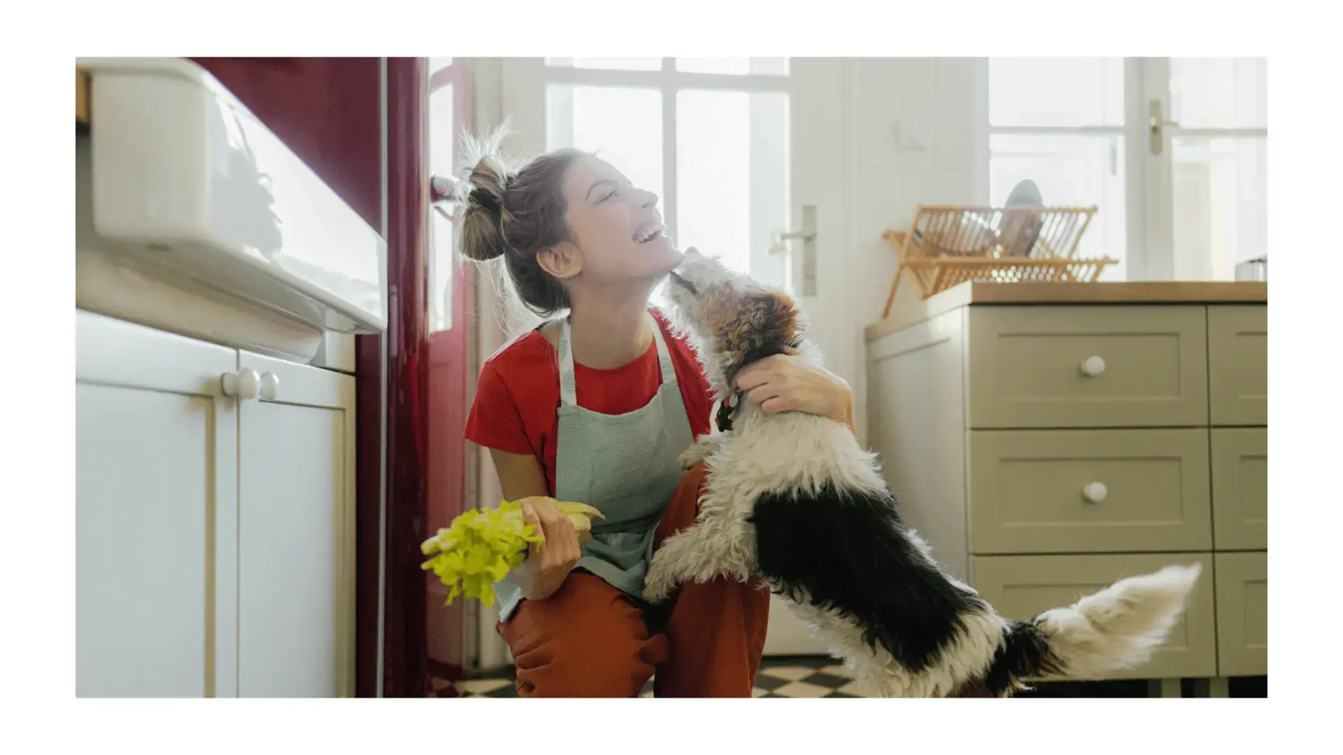 Woman with small dog in her kitchen